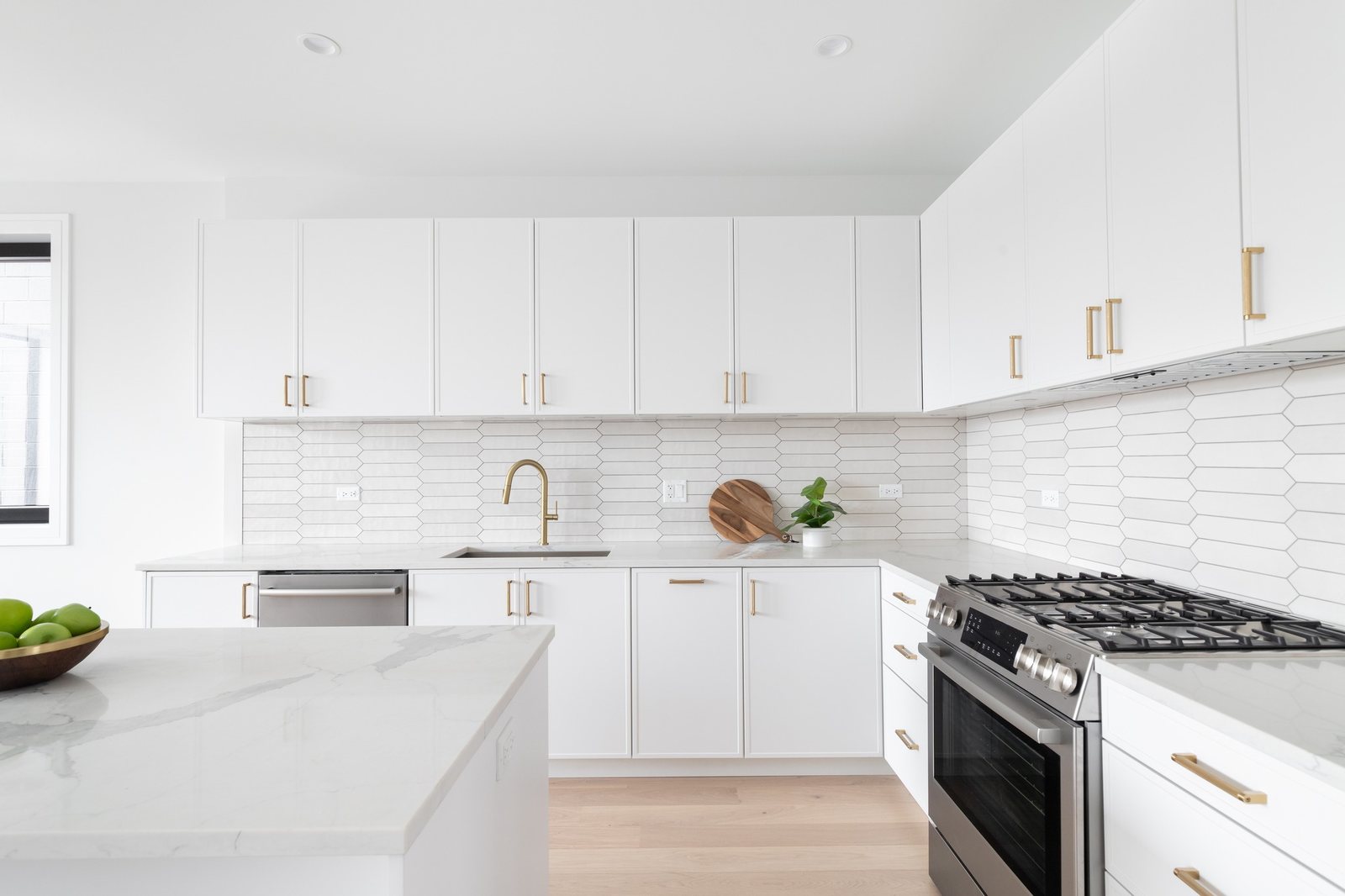 White kitchen with brass hardware