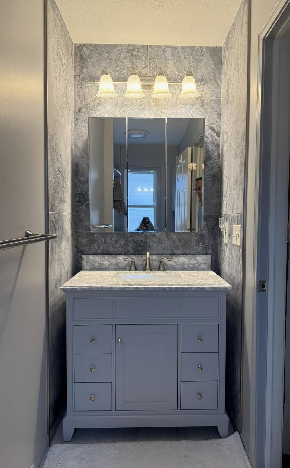 Grey bathroom vanity with a marble top