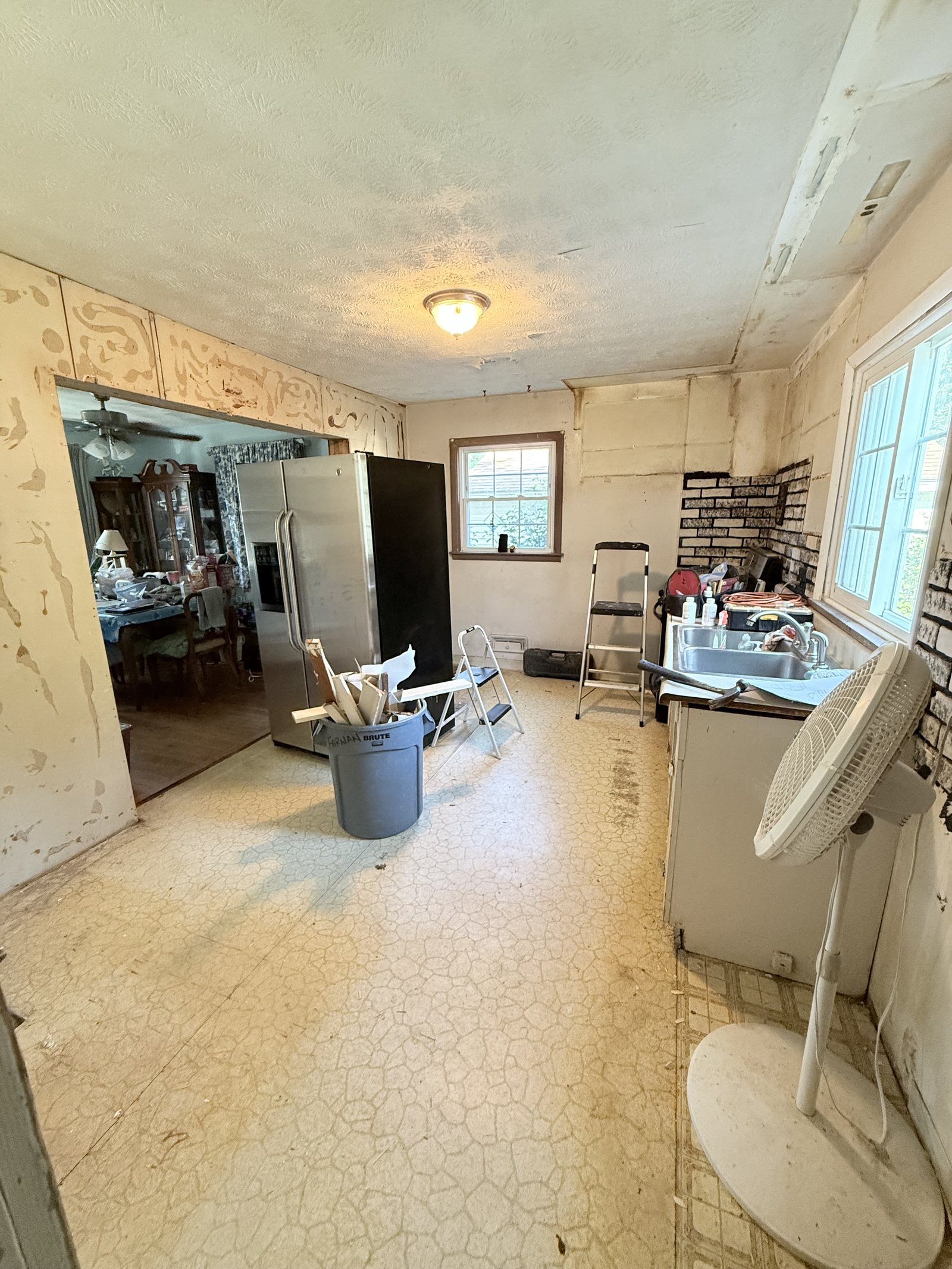 The kitchen stripped back to bare walls — before Dreamspace renovated it