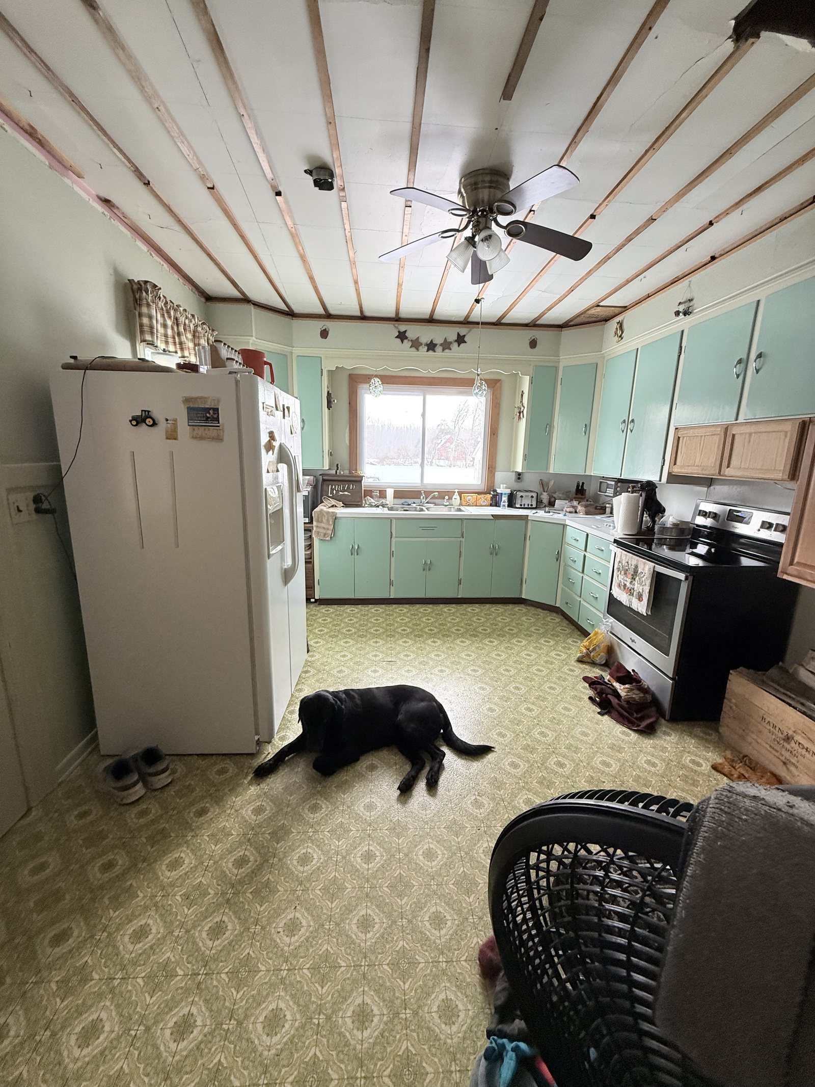 Original mint cabinets and a stripped ceiling — before Dreamspace renovated it