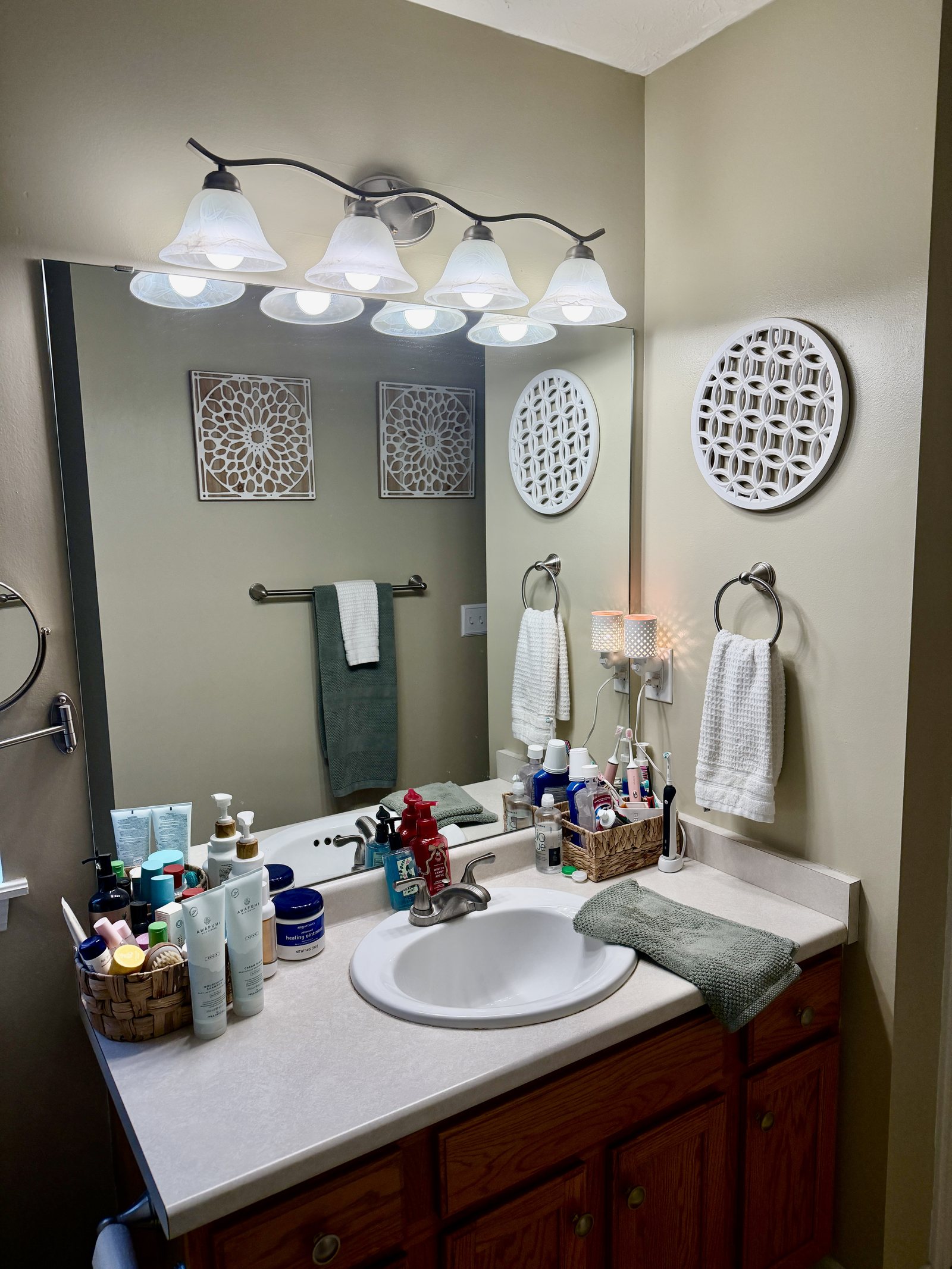 Builder-grade oak vanity and a frameless mirror — before Dreamspace renovated it
